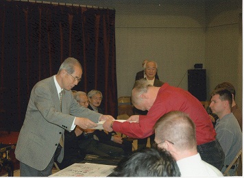 Sensei Wojo Receiving Promotion Certificate from Sensei Nakatani
